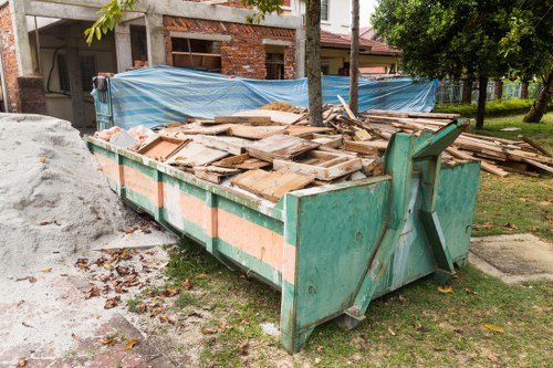 Team removing garden waste in Chingford, safety gear visible